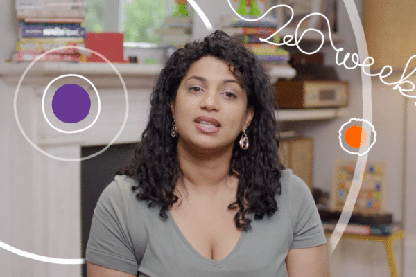 An image of a woman from an educational video. There is cursive text on screen which reads "26 weeks" as well as graphic design elements in the form of colourful circles